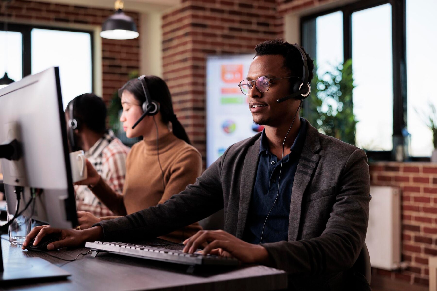 Customer support professionals working at desktop computers